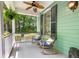 Cozy front porch with rocking chairs, ferns, and a ceiling fan at 5032 Coral Reef Dr, Johns Island, SC 29455