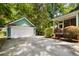 A detached garage with a white door and large driveway with basketball hoop at 5032 Coral Reef Dr, Johns Island, SC 29455