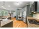 Kitchen with stainless steel appliances, gray cabinetry, granite countertops, and a breakfast bar at 5032 Coral Reef Dr, Johns Island, SC 29455