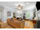 Bright living room with hardwood floors, a comfortable leather couch and great natural light at 5032 Coral Reef Dr, Johns Island, SC 29455
