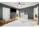 A well-lit primary bedroom boasts a TV, dresser, and white door, offering comfort and convenience at 5032 Coral Reef Dr, Johns Island, SC 29455