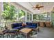 Relaxing screened porch with wicker furniture, ceiling fan, and outdoor dining area at 5032 Coral Reef Dr, Johns Island, SC 29455