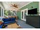 Spacious screened porch featuring a ceiling fan, outdoor TV, and plenty of room for entertaining at 5032 Coral Reef Dr, Johns Island, SC 29455