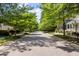 Neighborhood street view featuring lush trees and sidewalks in a quiet neighborhood at 5032 Coral Reef Dr, Johns Island, SC 29455