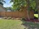 Backyard featuring a stained privacy fence with a landscaped border of plants and mulch at 5445 Ansley Trl, North Charleston, SC 29418