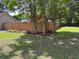 Backyard featuring a newly stained privacy fence with a landscaped border and lush lawn at 5445 Ansley Trl, North Charleston, SC 29418