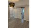 Bright bedroom with sliding barn door leading to a bathroom, wood floors and modern lighting at 5445 Ansley Trl, North Charleston, SC 29418