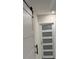 Modern white barn doors with black accents lead to additional rooms at 5445 Ansley Trl, North Charleston, SC 29418
