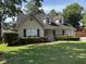 Charming home featuring manicured bushes, dormer windows, green shutters, and a well-kept lawn at 5445 Ansley Trl, North Charleston, SC 29418