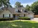 Charming home with a green lawn, dormer windows, green shutters, and a two-car garage at 5445 Ansley Trl, North Charleston, SC 29418