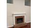 Close up of living room fireplace with white mantel and brick surround at 5445 Ansley Trl, North Charleston, SC 29418