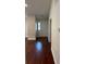 Inviting foyer featuring hardwood floors, a white front door, and neutral wall colors at 5445 Ansley Trl, North Charleston, SC 29418