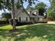 Inviting home exterior with dormer windows, a lush lawn, and neatly trimmed shrubs enhancing curb appeal at 5445 Ansley Trl, North Charleston, SC 29418