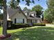 Inviting home exterior with dormer windows, a lush lawn, and neatly trimmed shrubs enhancing curb appeal at 5445 Ansley Trl, North Charleston, SC 29418