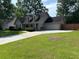 Charming single-Gathering home with manicured lawn, long driveway, fenced-in yard, and desirable curb appeal at 5445 Ansley Trl, North Charleston, SC 29418