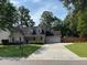 Charming single-Gathering home with a manicured lawn, long driveway, and a welcoming facade at 5445 Ansley Trl, North Charleston, SC 29418