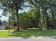 Lush front lawn with mature trees, showcasing a well-maintained yard and inviting curb appeal at 5445 Ansley Trl, North Charleston, SC 29418
