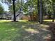 View of home exterior on a lush green lawn, complemented by mature trees and privacy fence at 5445 Ansley Trl, North Charleston, SC 29418
