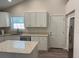 Bright kitchen with white cabinets, granite countertops, stainless steel appliances, and an island at 5445 Ansley Trl, North Charleston, SC 29418