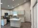 Bright kitchen featuring white cabinets, granite countertops, stainless steel appliances, and an island at 5445 Ansley Trl, North Charleston, SC 29418