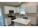 Beautiful kitchen featuring white cabinets, granite countertops, stainless steel appliances, and an island at 5445 Ansley Trl, North Charleston, SC 29418