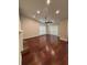 Open living room with hardwood floors, modern ceiling fan, fireplace, and natural light from windows at 5445 Ansley Trl, North Charleston, SC 29418