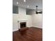 Bright living room featuring a brick fireplace, hardwood floors, and modern ceiling fan for a cozy atmosphere at 5445 Ansley Trl, North Charleston, SC 29418