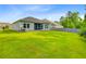 Spacious backyard with green lawn and mature trees, plus a screened-in porch at 578 Mountain Laurel Cir, Goose Creek, SC 29445