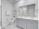 Stylish bathroom featuring a double vanity with gray cabinets and a large mirror at 578 Mountain Laurel Cir, Goose Creek, SC 29445