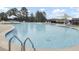 Large community pool with ladders surrounded by chairs and umbrellas for shade and relaxation at 578 Mountain Laurel Cir, Goose Creek, SC 29445