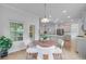 Dining area showcases a modern table and easy access to the kitchen and outdoor patio at 578 Mountain Laurel Cir, Goose Creek, SC 29445