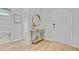 Bright entryway featuring wood-look flooring, a decorative table with a gold mirror, and access to other rooms at 578 Mountain Laurel Cir, Goose Creek, SC 29445