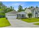 Charming single-story home featuring a manicured lawn, attached two-car garage, and a welcoming front porch at 578 Mountain Laurel Cir, Goose Creek, SC 29445