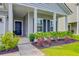 Inviting front porch with tasteful landscaping, dark blue door, and classic columns for added curb appeal at 578 Mountain Laurel Cir, Goose Creek, SC 29445