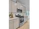 Well-lit kitchen with gray cabinets, stainless steel appliances, and quartz countertops at 578 Mountain Laurel Cir, Goose Creek, SC 29445