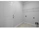 Bright laundry area with storage rack, tile flooring, and convenient washer/dryer hookups at 578 Mountain Laurel Cir, Goose Creek, SC 29445
