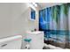 Compact bathroom with a modern vanity, toilet, and vibrant shower curtain adding a splash of color at 5806 Robinhood Dr, Hanahan, SC 29410