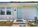 Close up of the white house's light blue front door, number, and front porch at 5806 Robinhood Dr, Hanahan, SC 29410
