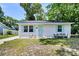 Charming single-story home featuring a light blue front door, matching shutters, and a cozy bench at 5806 Robinhood Dr, Hanahan, SC 29410