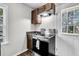 Galley kitchen featuring an oven, and wood cabinets offering a functional space with an adjacent door and window at 5806 Robinhood Dr, Hanahan, SC 29410