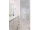 Contemporary bathroom featuring marble floors, a sleek vanity, and modern fixtures at 601 Ocean Blvd, Isle of Palms, SC 29451