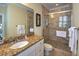Bathroom with a large vanity, granite countertop and a tiled glass shower with a bench at 601 Ocean Blvd, Isle of Palms, SC 29451