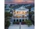 Three-story beach house featuring multiple balconies and a spiral staircase with lush landscaping at 601 Ocean Blvd, Isle of Palms, SC 29451