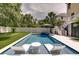 Backyard with an in-ground pool, hot tub, lounge chairs, putting green and a white picket fence at 601 Ocean Blvd, Isle of Palms, SC 29451