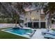 Backyard with an in-ground pool, hot tub, lounge chairs, and a manicured lawn at 601 Ocean Blvd, Isle of Palms, SC 29451