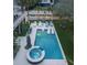 Backyard with an in-ground pool, hot tub, lounge chairs, and a well-manicured lawn at 601 Ocean Blvd, Isle of Palms, SC 29451