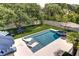In-ground pool and hot tub surrounded by a manicured lawn and white picket fence at 601 Ocean Blvd, Isle of Palms, SC 29451