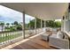 Inviting covered porch featuring comfortable seating and scenic views of lush tropical landscape and neighborhood at 601 Ocean Blvd, Isle of Palms, SC 29451