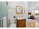 Bathroom with a vanity, mirror, toilet, and a glass-enclosed shower adjacent to a bedroom entrance at 617 Willdrew Ln, Moncks Corner, SC 29461
