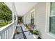Spacious front porch featuring a charming bench, potted plants, and ample space for relaxation and enjoying the outdoors at 617 Willdrew Ln, Moncks Corner, SC 29461